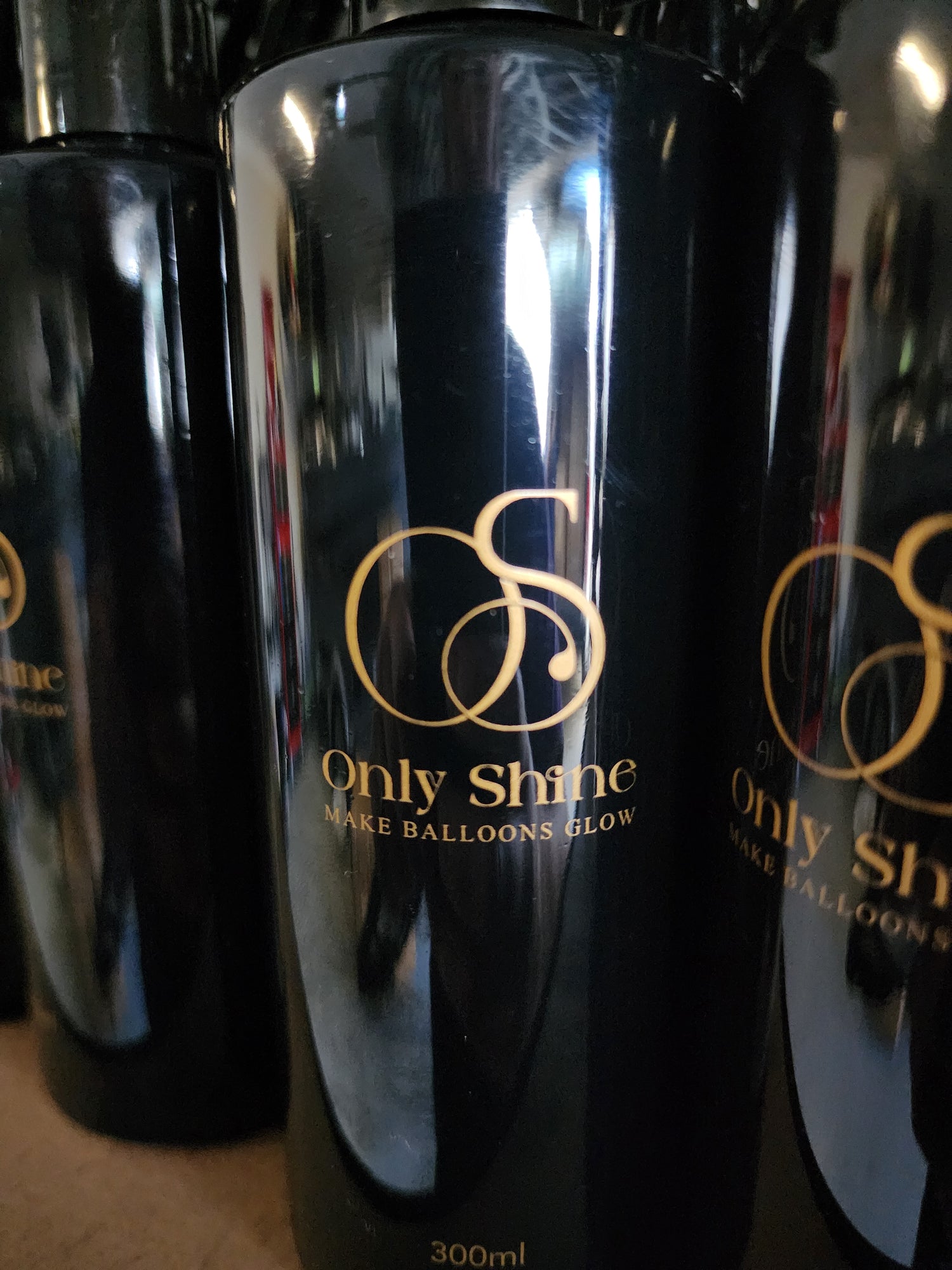 Close up of one of the Only Shine bottles showing its luxury logo